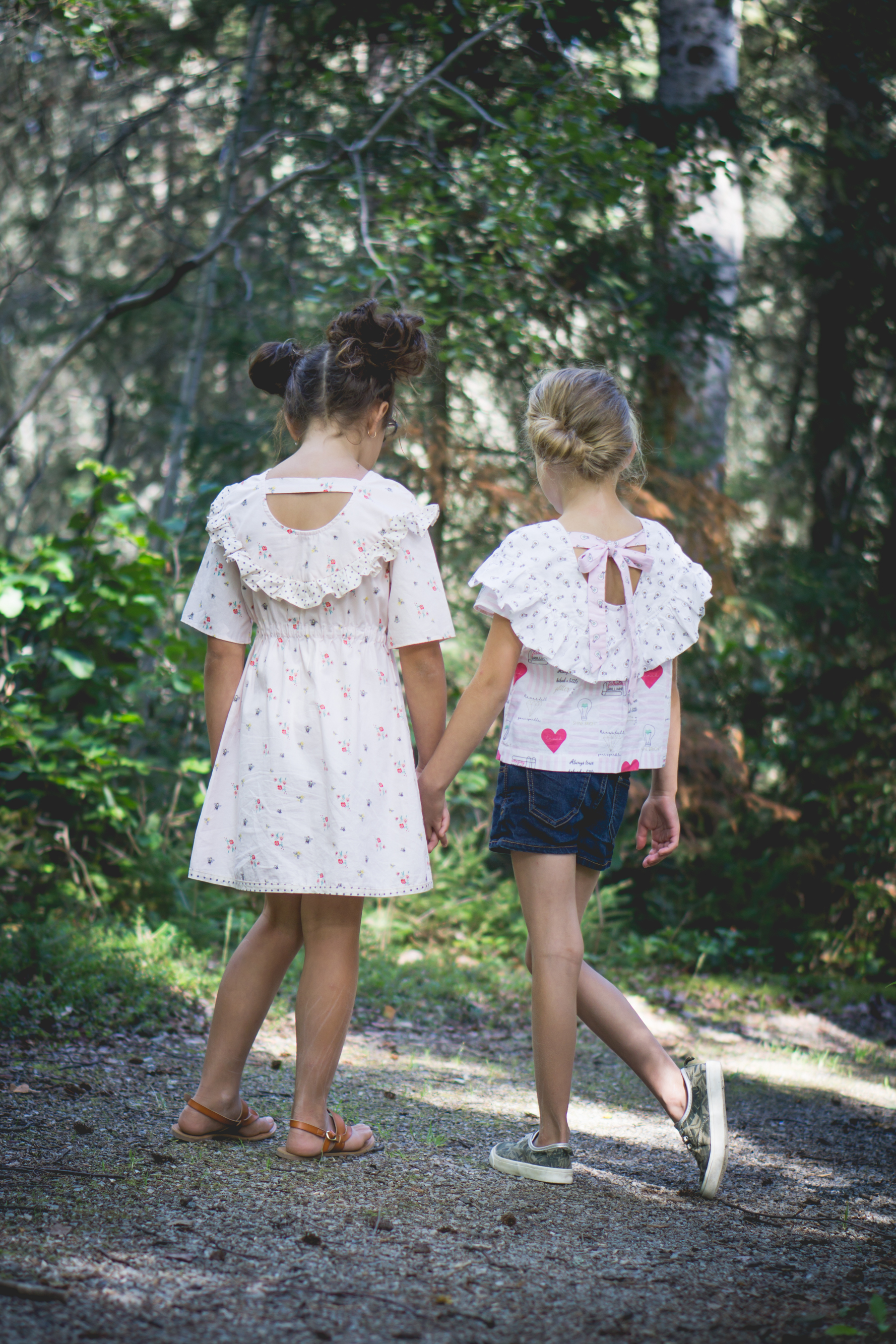 Raven dress and top. Gathered elastic waist dress with scoop back and simple band. Short ruffles along the yoke. Shirt length has split hem detail and ties across the scoop. Long ruffle length.