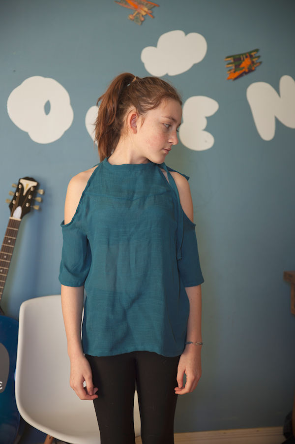 The cold shoulder Lynx dress with mid length sleeves. High neckline with tie on one side.