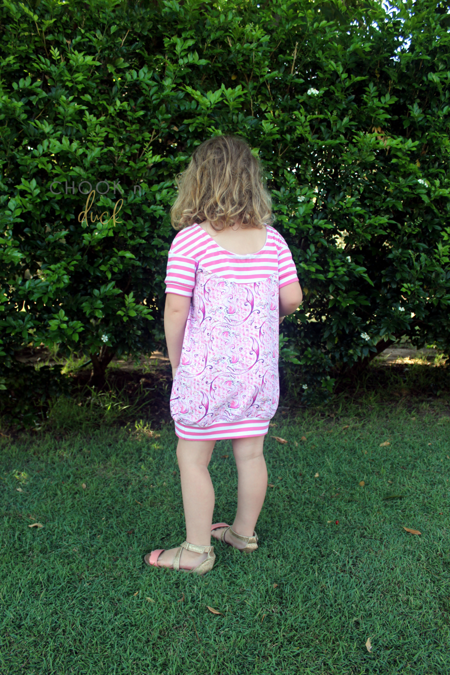 Rhubarb raised scoop back, dropped shoulder in tunic length. No ruffle option and banded hem.