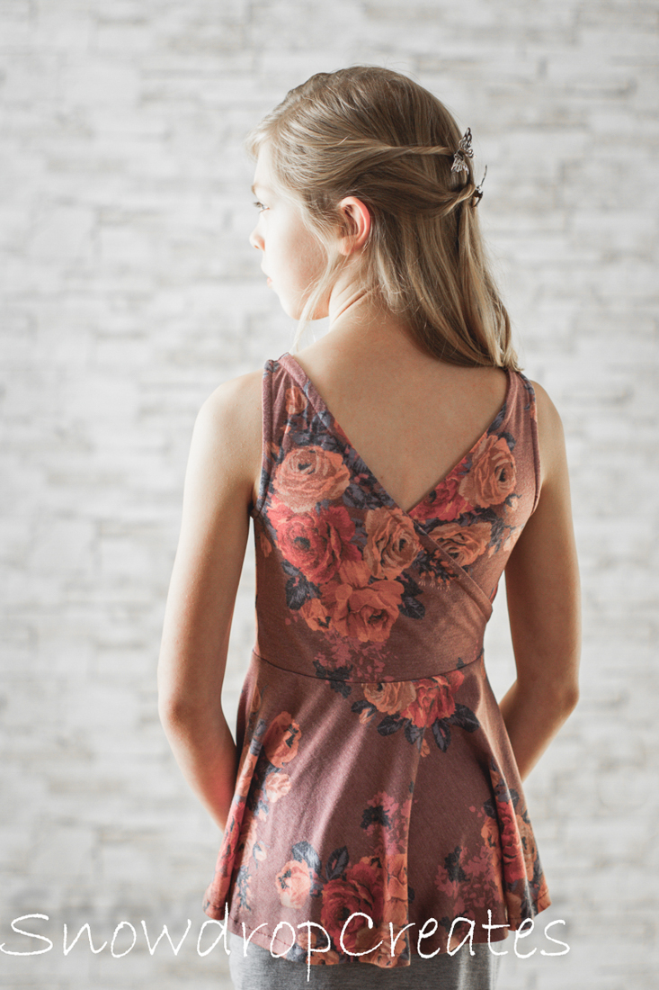 Dandelion Peplum tank with criss cross back and hidden facings for a clean look.