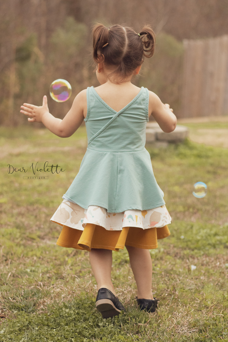 Dandelion Peplum tank with criss cross back and hidden facings for a clean look. Long peplum length over the Pinecone skirt for a layered skirt/dress style.