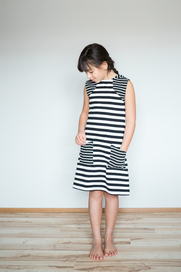 Moss knee length knit dress or swim cover with pockets and angled bodice detail.