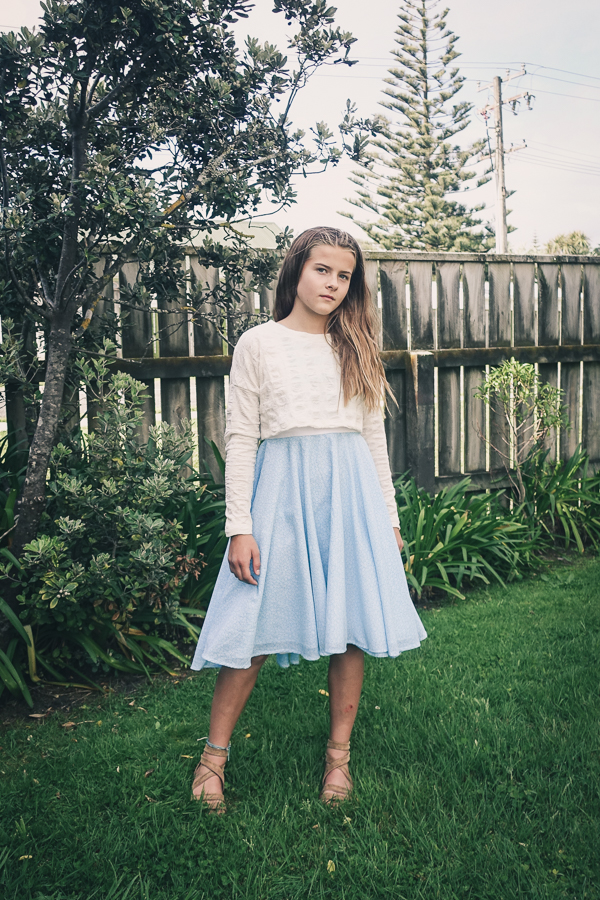 Tundra sweater in waist length and long sleeves and using sweater knit fabric. Shown over the Fireweed flounce dress.