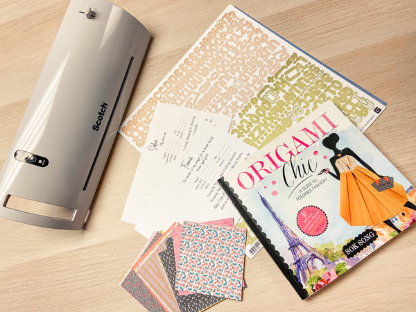 Supplies for creating a laminated card for keeping track of sewing measurements.