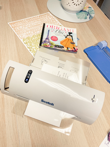 Supplies for creating a laminated card for keeping track of sewing measurements.