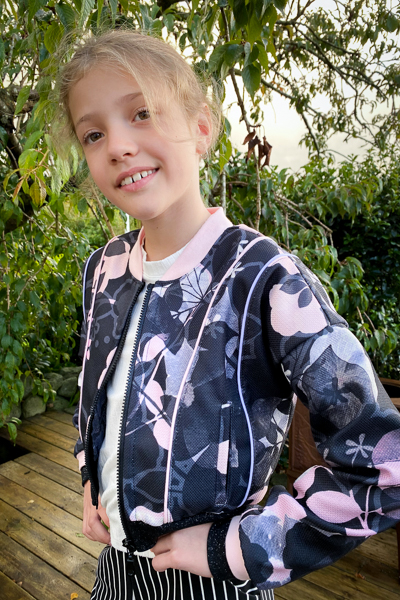 The Rose Hip jacket in waist length. The bomber style neckline, double cuffs, and welt pockets.