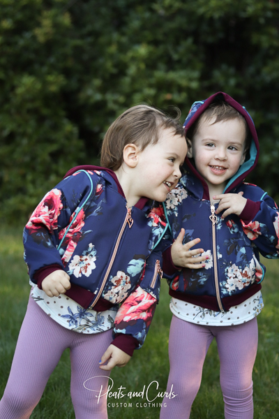 Cute Rose Hip jackets for these adorable twin girls. With piping and welt pockets and gusseted hoods.