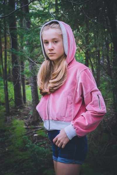 A velvet Rose Hip jacket. Waist length with zippered sleeve pocket, welt pockets and gusseted hood.