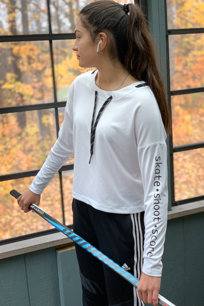 The Miss Tundra top in waist length and long sleeves with grommets on the neckline and vinyl lettering on the sleeve.