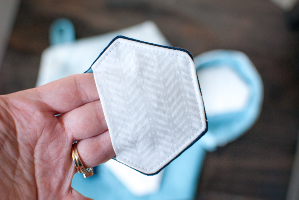 Unique hexagon shaped reusable make-up removing pad with finger hold pocket.