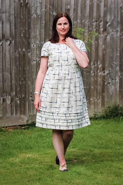 The Miss Haze dress with pleated bodice, pleated hem, and waist ties. Available from Sofiona Designs in junior miss sizes 0-20.