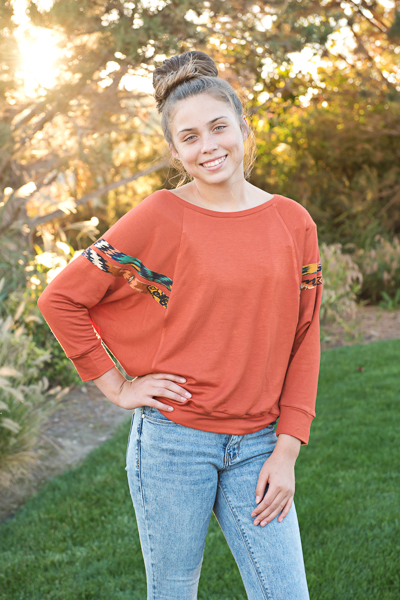 A raglan sweater with batwing sleeves and stripe details  in junior miss sizes 0-20.