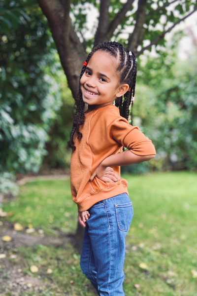 A raglan sweater with batwing sleeves and elastic waistband in girls' sizes 2-16.