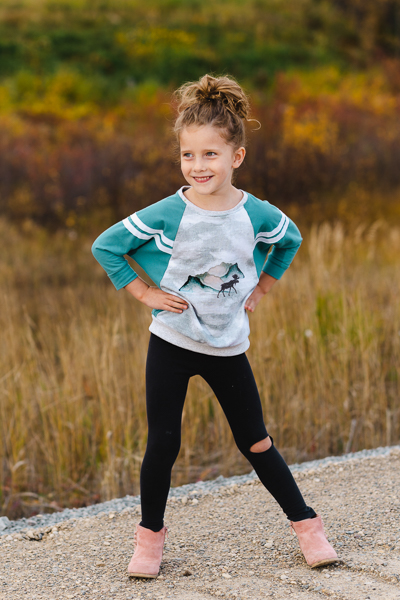 A raglan sweater with batwing sleeves with stripe details in girls' sizes 2-16. Excellent for custom panels.