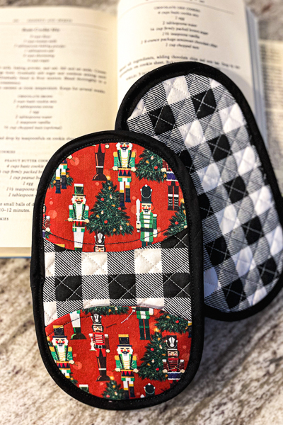 The Solar Flare potholders by Sofiona Designs in a holiday print and machine quilted.
