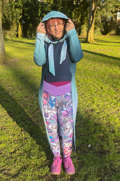 Crop front with long back hooded sweater with princess seams.