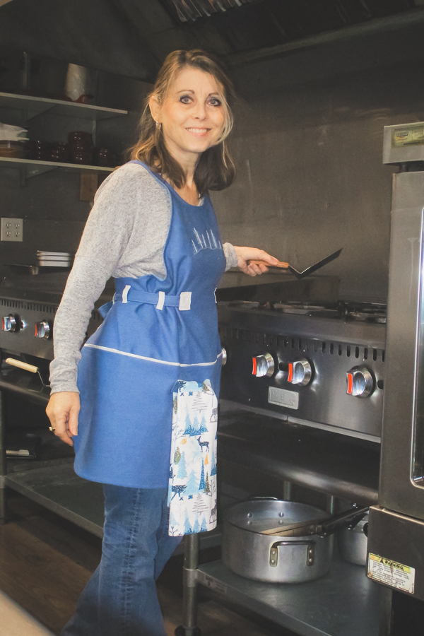 The pieced Poppy apron in adult sizing with a waffle towel from Raspberry Creek Fabrics.
