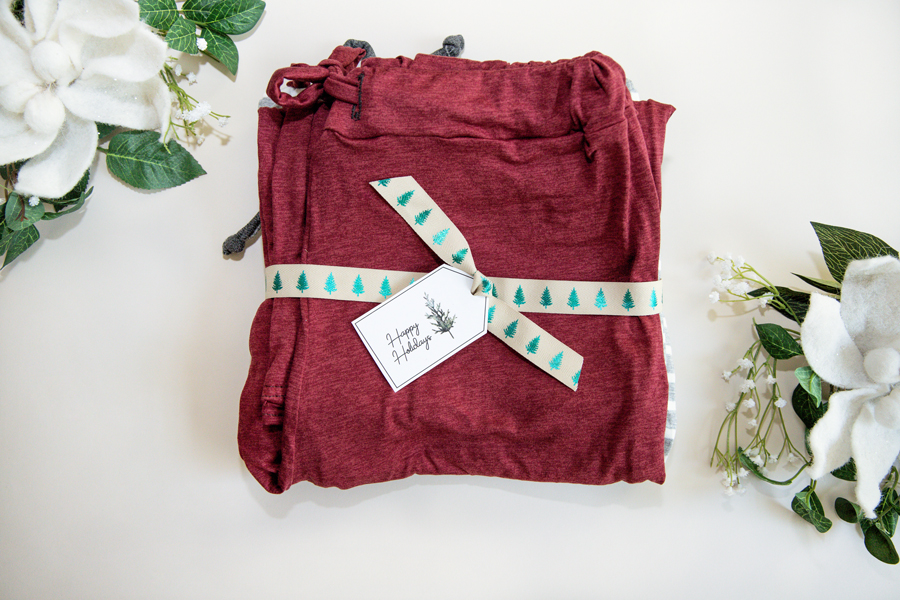 Folded pair of PJ pants with a holiday printable for gift-giving.